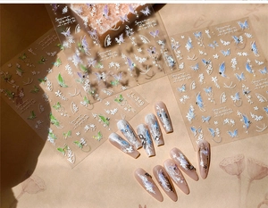 Detailed macro view of TL-348 3D butterfly and floral nail stickers on long fake nails
