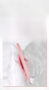 Nahaufnahme des rosa herzförmigen Gua Sha Tools aus Harz mit dicken glatten Kanten