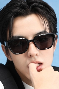 Detail of square black polarized sunglasses with metallic rivets and dark lenses