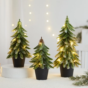 Mini tabletop Christmas trees with warm LED lights and black base for holiday decor