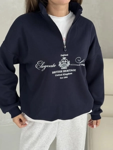 Detail of the half-zip collar and navy cotton sweatshirt with vintage printed lettering