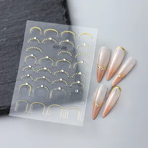 Détail de stickers 5D pour ongles avec lignes dorées en U et strass blancs brillants