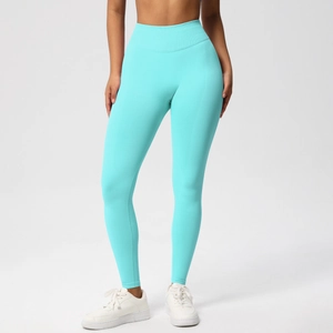 Macro detail of high-waist seamless yoga pants in teal blue with elastic knit fabric