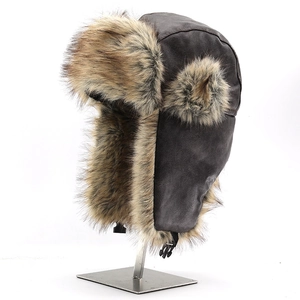 Close-up of brown leather trapper hat featuring thick faux fur lining and windproof buckle