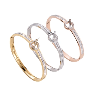 Minimalist asteroid bangle with pavé diamonds and ring-bar clasp in gold, silver, and rose gold