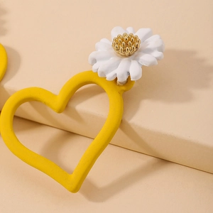 Sweet asymmetric daisy and yellow heart drop earrings in a minimalist jewelry style