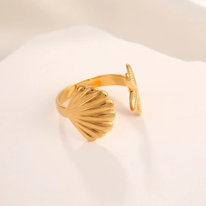 Detail of gold seashell and starfish design on minimalist stainless steel open ring