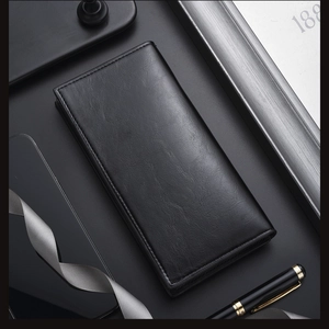 Detailed view of black leather wallet with natural lychee texture and fine stitching