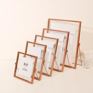 Set of five rose gold minimalist metal frames with U-shaped stands and glass panels