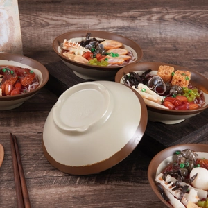 Authentic large bowl of snail noodles food model displayed on a dark wooden table