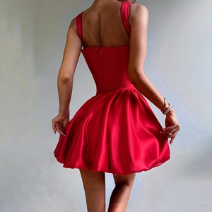 Detail view of the back of a red satin mini cocktail dress with a slim fit waistline