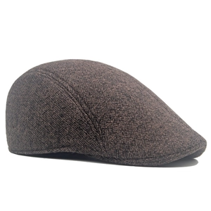 Detailed side view of dark brown herringbone textured wool ivy cap with precise stitching