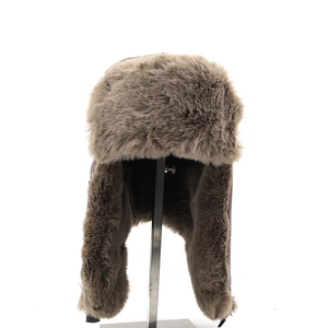 Close-up of brown faux fur lining and plush ear flaps on a winter trapper hat