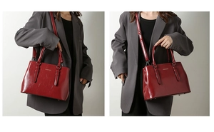 Detail of burgundy PU leather tote bag showing glossy texture and fashion logo