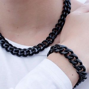 Men's bold black stainless steel Cuban link necklace and bracelet jewelry set on model