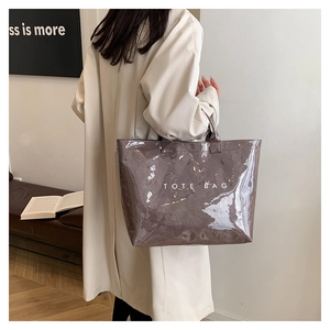 Minimalist translucent grey PVC tote bag with white TOTE BAG lettering detail
