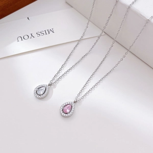 Exquisite teardrop zircon pendants in white and pink on silver chains with a gift card