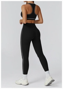 Close-up of black yoga set featuring white trim accents and high-waisted compression fit