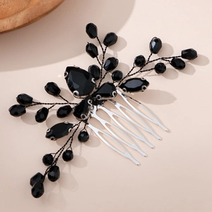 Macro view of black crystals and beaded branch details on a vintage bridal hair comb
