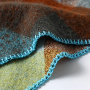 Close-up of color-block scarf texture with detailed blue whipstitch edge finish