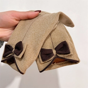 Detail showing plush lining and cute bow on khaki warm winter touchscreen gloves