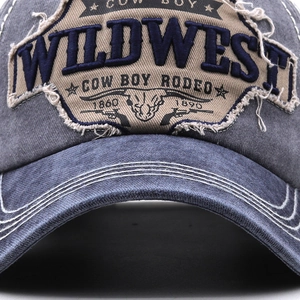 Macro shot of 3D embroidery on vintage denim baseball cap with Wild West patches
