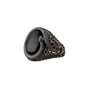 Men's vintage silver snake ring with a large black oval gemstone and green zircon accents
