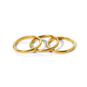 Detailed view of three minimalist 18k gold-plated stainless steel stackable thin rings