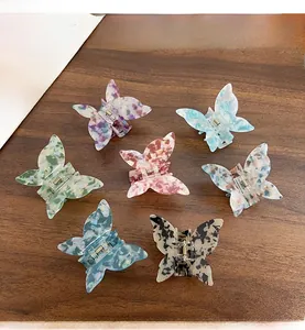 Collection of seven iridescent acetate butterfly hair claws in various vibrant marble colors