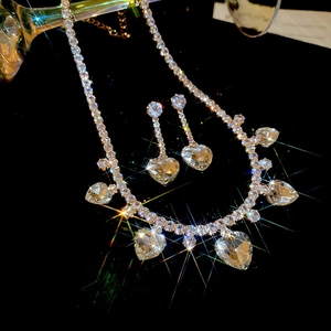 Sparkling silver zircon heart tassel necklace and earrings jewelry set on black background