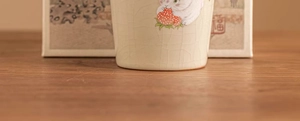 Macro shot of Ru-kiln ceramic teacup with ice-crack glaze and cute strawberry bunny