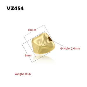Detailed view of 10x9mm gold baroque spacer bead VZ454 with 2.0mm hole and polished finish