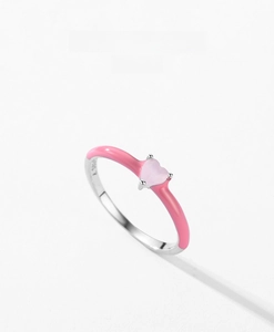 Macro view of S925 sterling silver ring featuring pink enamel coating and heart stone