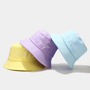 Minimalist cotton bucket hats in yellow, purple and blue with OK AND? embroidery