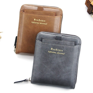 Close-up of matte men's wallets in brown and grey with gold lettering and precise stitching