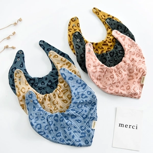 Detail showing colorful leopard print muslin cotton baby bibs with adjustable snap buttons