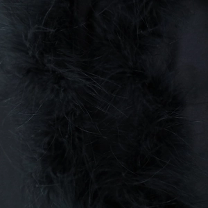 Close-up macro shot showing the soft black feather texture and fluffy trim of the dress