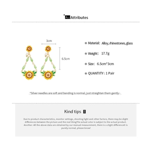 Detail view of sunflower bee drop earrings with crystal accents and dimensions