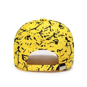 Yellow graffiti cotton baseball cap with black splatter paint and metal buckle adjustment