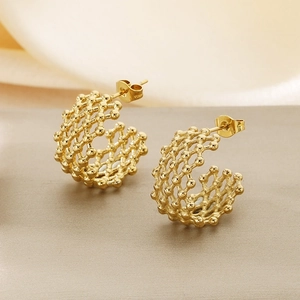 Close-up of 18K gold-plated C-shaped earrings with hollow woven texture and butterfly clasp