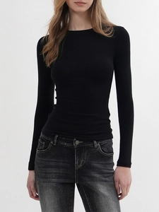 Close-up of slim fit black long sleeve t-shirt with crew neck and ribbed texture