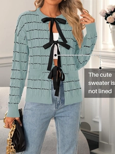 Women's blue cable knit cardigan sweater with black stripes and front bow ties