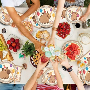 Overhead view of Capybara themed party tableware set with colorful plates and napkins