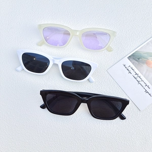 Chic retro cat eye sunglasses in three colors on a white textured background