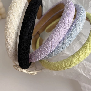 Detailed macro view of high-quality lace crochet textures on five colorful padded headbands