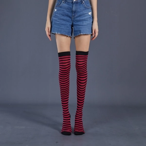 Detail of red and black striped over-the-knee socks showing stretch knit fabric fit