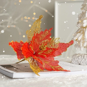 Sparkling red and gold artificial Christmas flower on magazine for tree decoration