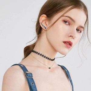 Set of blue zircon stud earrings and floral lace choker necklace on a model