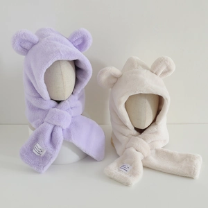 Detail of plush bear ear hooded scarves in purple and beige with soft faux fur texture