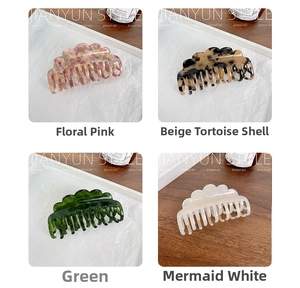 Close-up of acetic acid hair claws in floral pink, tortoiseshell, green and pearl white